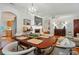 Spacious dining area connects to the living room with hardwood floors and a modern chandelier at 4647 General Pershing Dr, Charlotte, NC 28209
