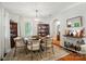 Cozy dining area featuring hardwood floors, a display cabinet, and ample natural light at 4647 General Pershing Dr, Charlotte, NC 28209