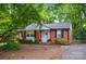 Charming brick home featuring lush landscaping and inviting curb appeal at 4647 General Pershing Dr, Charlotte, NC 28209