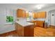 Bright kitchen featuring hardwood floors, white countertops, and lots of light at 4647 General Pershing Dr, Charlotte, NC 28209