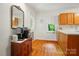The kitchen features a coffee bar and wood cabinets with a view out the window at 4647 General Pershing Dr, Charlotte, NC 28209