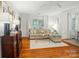 Sunlit living room with hardwood floors, a comfortable sofa, and elegant decor at 4647 General Pershing Dr, Charlotte, NC 28209