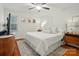 Cozy main bedroom boasts a comfortable bed, hardwood floors, and ample natural light at 4647 General Pershing Dr, Charlotte, NC 28209