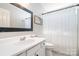 Bright bathroom featuring a white vanity, black framed mirror, and shower with curtain at 4711 Sunburst Ln, Charlotte, NC 28213