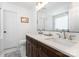 Bathroom with double sink vanity, large mirror, and a separate toilet room at 4711 Sunburst Ln, Charlotte, NC 28213