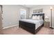 Well lit bedroom with large bed, wood floors, and picture window at 4711 Sunburst Ln, Charlotte, NC 28213