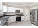 Bright kitchen with stainless steel appliances, granite countertops, and white cabinetry at 4711 Sunburst Ln, Charlotte, NC 28213