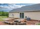 Home's rear exterior with a wooden deck, sliding glass door, and well-kept yard with a fire pit at 5052 Swinging Bridge Rd, Conover, NC 28613