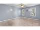 This is a spacious bedroom featuring neutral carpet, ceiling fan, and two windows at 5052 Swinging Bridge Rd, Conover, NC 28613