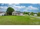 Charming single-story home featuring a well-manicured lawn, blue front door, and attached garage at 5052 Swinging Bridge Rd, Conover, NC 28613