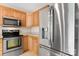 Kitchen showcasing stainless steel refrigerator and range with natural wood cabinets at 5052 Swinging Bridge Rd, Conover, NC 28613
