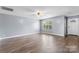 Bright living room featuring hardwood floors, a ceiling fan, and a large window at 5052 Swinging Bridge Rd, Conover, NC 28613