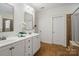 This bathroom features double sinks, white cabinetry, a neutral color scheme, and a glass-enclosed shower at 5663 Morris Hunt Dr, Fort Mill, SC 29708