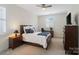 This bedroom has a ceiling fan and a tv with neutral carpet and a view to the windows at 5663 Morris Hunt Dr, Fort Mill, SC 29708