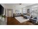 Spacious bonus room features sectional sofa, hardwood flooring, and modern exercise equipment at 5663 Morris Hunt Dr, Fort Mill, SC 29708