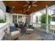 Relaxing covered patio with comfortable seating, ceiling fans, and an outdoor television at 5663 Morris Hunt Dr, Fort Mill, SC 29708