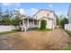 Spacious home exterior featuring well-maintained landscaping, a screened in porch, and plenty of parking at 5663 Morris Hunt Dr, Fort Mill, SC 29708