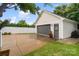 Detached garage with gray door, adjacent to grassy lawn, surrounded by a privacy fence at 5663 Morris Hunt Dr, Fort Mill, SC 29708