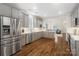 Modern kitchen with stainless steel appliances and gray cabinetry with an adjoining dining area at 5663 Morris Hunt Dr, Fort Mill, SC 29708