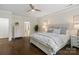 Serene main bedroom features a decorative ceiling fan, hardwood floors, and a view of the bathroom at 5663 Morris Hunt Dr, Fort Mill, SC 29708