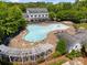 Community pool and clubhouse surrounded by lounge chairs, lush trees, and manicured landscaping at 5663 Morris Hunt Dr, Fort Mill, SC 29708