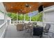 Relaxing outdoor porch with wood ceiling, ceiling fans, and comfortable wicker seating area at 5663 Morris Hunt Dr, Fort Mill, SC 29708
