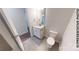 Bright powder room featuring a white vanity and tiled floor and a modern toilet at 601 Queens Rd, Gastonia, NC 28052