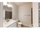 Bathroom featuring a white vanity with a marble countertop, gray tile, and modern fixtures at 601 Queens Rd, Gastonia, NC 28052