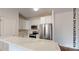 Stylish kitchen with white cabinets, stainless steel appliances, marble countertops, and an island with a sink at 601 Queens Rd, Gastonia, NC 28052