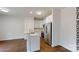 Open-concept kitchen featuring white cabinets, stainless steel appliances, and a breakfast bar with marble countertop at 601 Queens Rd, Gastonia, NC 28052