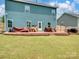 Backyard with a concrete patio and covered furniture, grassy lawn at 6381 Trinity Crossing Cir, Kannapolis, NC 28081