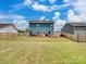 Fenced backyard featuring a patio, with covered furniture, and a grassy lawn at 6381 Trinity Crossing Cir, Kannapolis, NC 28081