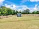 Spacious fenced backyard featuring a storage shed and lush green grass at 6381 Trinity Crossing Cir, Kannapolis, NC 28081