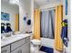 Stylish bathroom with modern vanity, new fixtures and bright yellow and gray decor at 6381 Trinity Crossing Cir, Kannapolis, NC 28081