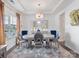 Elegant dining room with a modern chandelier, a round table, and decorative accents at 6381 Trinity Crossing Cir, Kannapolis, NC 28081