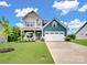 Beautiful two-story home with a well-manicured lawn, two-car garage, and a welcoming covered front porch at 6381 Trinity Crossing Cir, Kannapolis, NC 28081