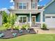 Charming home exterior with landscaped yard, stone accents and inviting front porch at 6381 Trinity Crossing Cir, Kannapolis, NC 28081