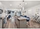 Open kitchen showcasing an island with seating, granite counters, and stainless steel appliances flowing into the living area at 6381 Trinity Crossing Cir, Kannapolis, NC 28081