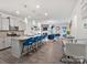 Modern kitchen open to the living room, featuring a large island with seating and stylish pendant lighting at 6381 Trinity Crossing Cir, Kannapolis, NC 28081