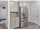 Bright kitchen with modern stainless steel appliances, stylish gray cabinetry, and granite countertops at 6381 Trinity Crossing Cir, Kannapolis, NC 28081