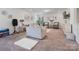 Inviting living room with neutral walls, plush carpet, stylish decor, and modern furniture at 6381 Trinity Crossing Cir, Kannapolis, NC 28081