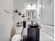 Compact powder room featuring a vanity with a vessel sink and decorative floating shelves at 6381 Trinity Crossing Cir, Kannapolis, NC 28081