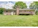 Brick home with a wooden deck, chimney and large grassy backyard at 6573 Weldon Nw Cir # 22, Concord, NC 28027