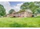 Back of the house showcasing a wooden deck with stairs in large grass filled backyard at 6573 Weldon Nw Cir # 22, Concord, NC 28027