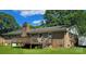 Brick home backyard view with a wooden deck, brick chimney, and outdoor space for relaxation and entertaining at 6573 Weldon Nw Cir # 22, Concord, NC 28027