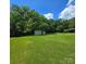 Expansive backyard with lush green grass, storage shed, and plenty of room for outdoor activities at 6573 Weldon Nw Cir # 22, Concord, NC 28027