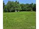 Sprawling backyard with lush green lawn and mature trees, offering privacy at 6573 Weldon Nw Cir # 22, Concord, NC 28027