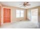 Inviting bedroom with plush carpeting, ceiling fan, and a large double window at 6573 Weldon Nw Cir # 22, Concord, NC 28027