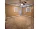 Bedroom with neutral carpeting, a ceiling fan, and natural light at 6573 Weldon Nw Cir # 22, Concord, NC 28027