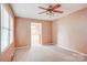 Cozy bedroom with neutral carpeting, ceiling fan, and a bright window at 6573 Weldon Nw Cir # 22, Concord, NC 28027